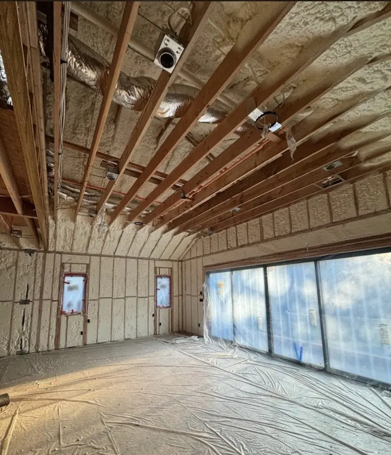 Interior walls and ceiling insulated with spray foam during new construction in Genoa
